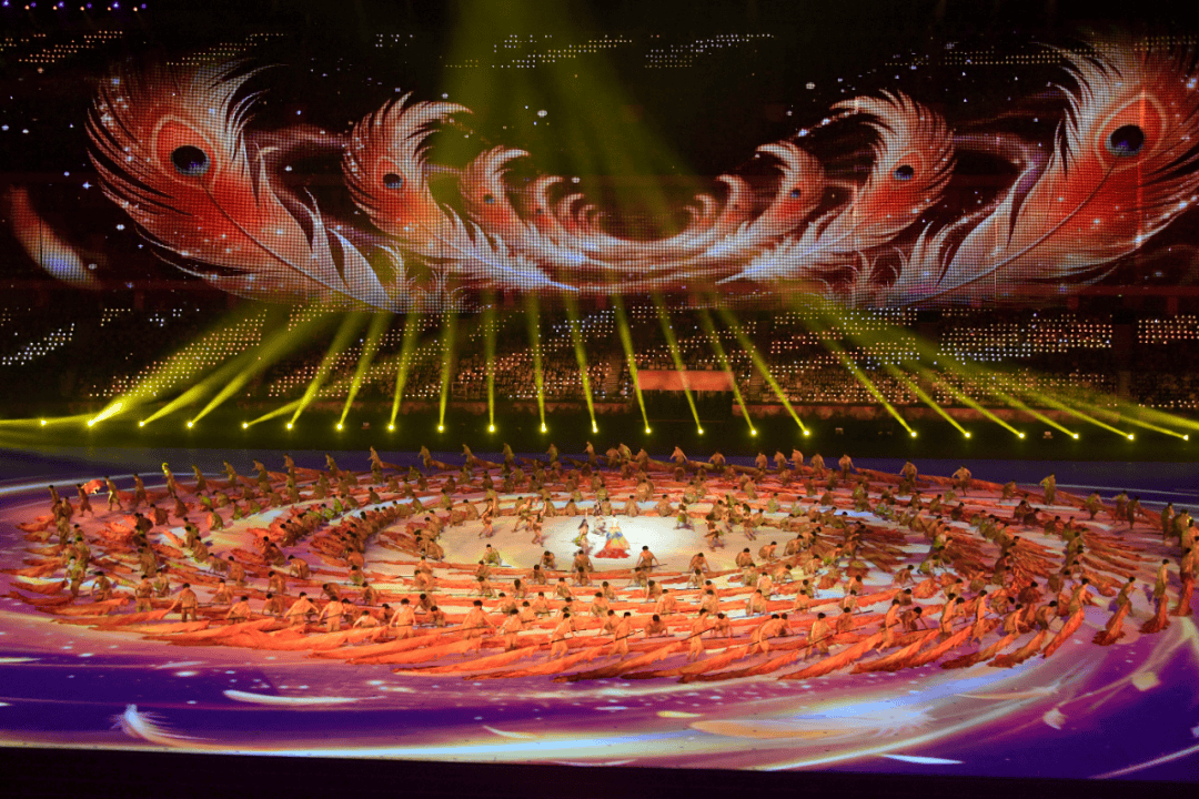 Phoenix imagery combining audience lighting, LED mesh screens and dance at the Shandong Provincial Games