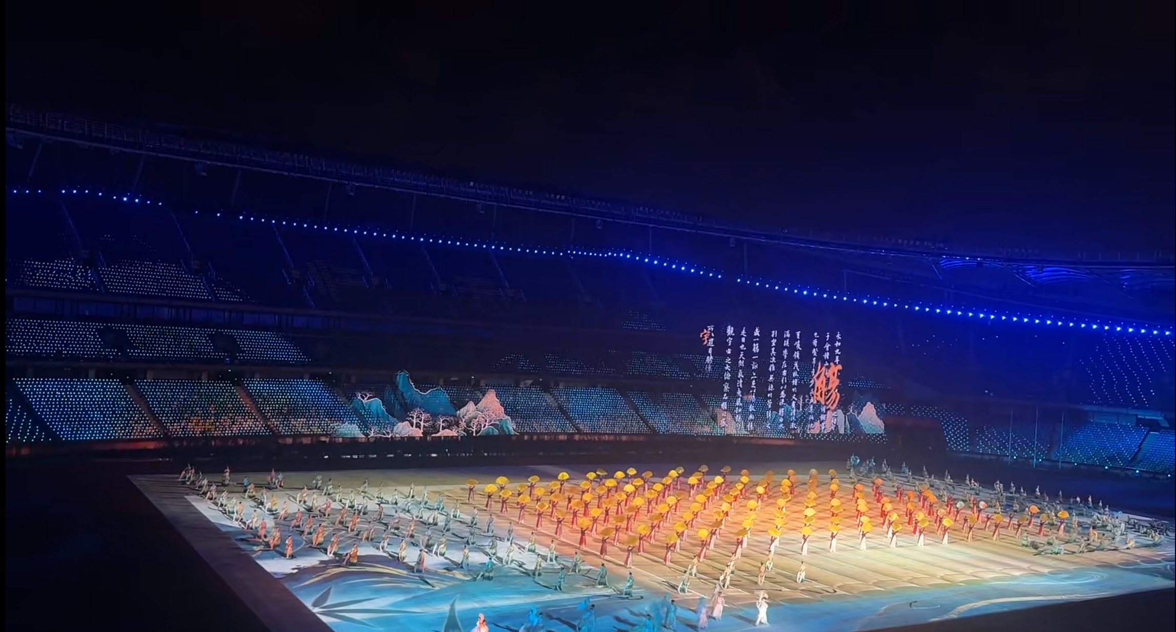 Mountain imagery extending from LED mesh screens into the audience lighting at the Shandong Provincial Games